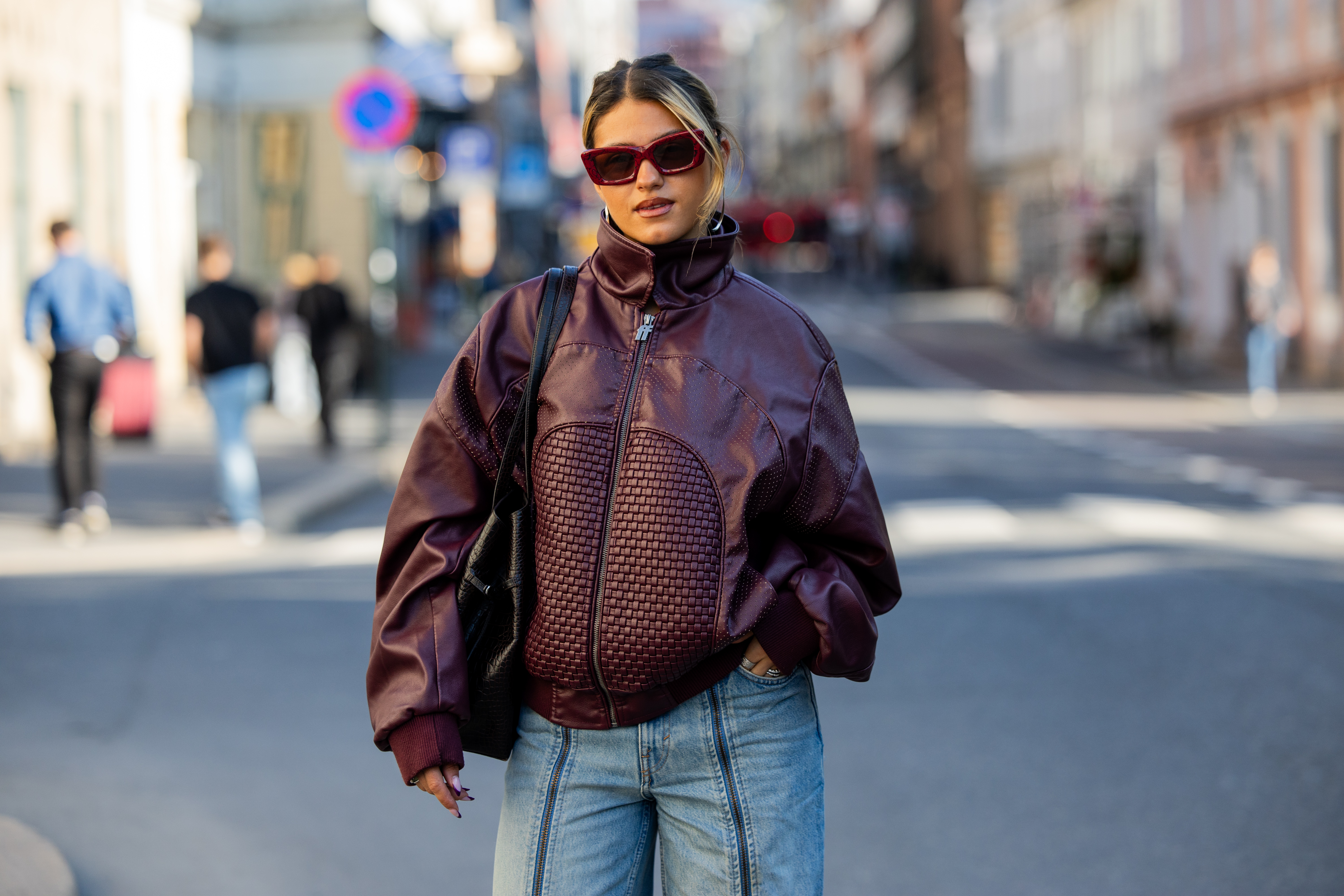 OSLO, NORWAY - SEPTEMBER 02: Isabelle Eberdean wears oversized burgundy zipper jacket, red framed sunglasses, two tone denim jeans light washed, black bag during Oslo Fashion Week on September 02, 2026 in Oslo, Norway. (Photo by Christian Vierig/Getty Images)